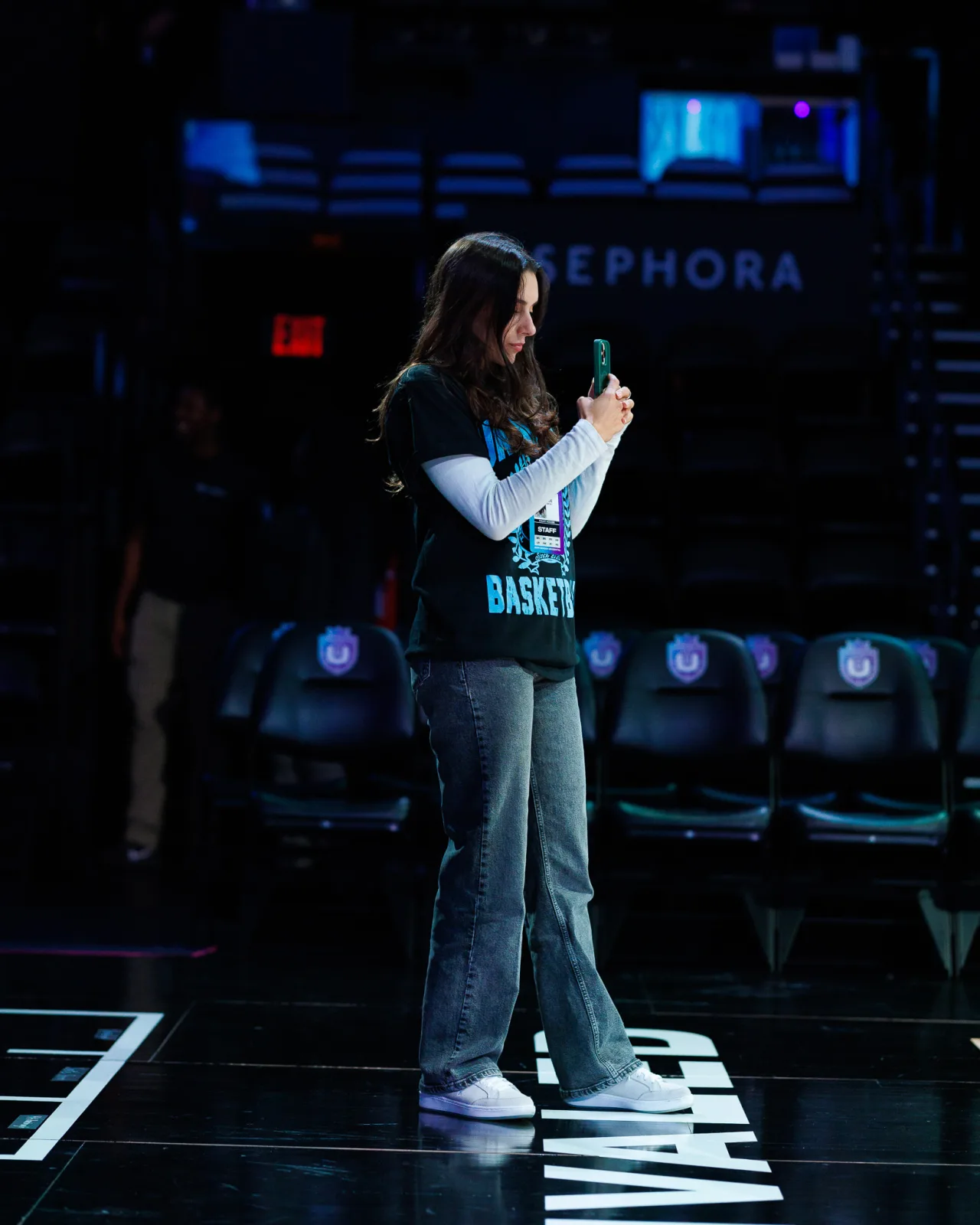 Camilla Flefil filming content courtside during an Unrivaled Basketball game