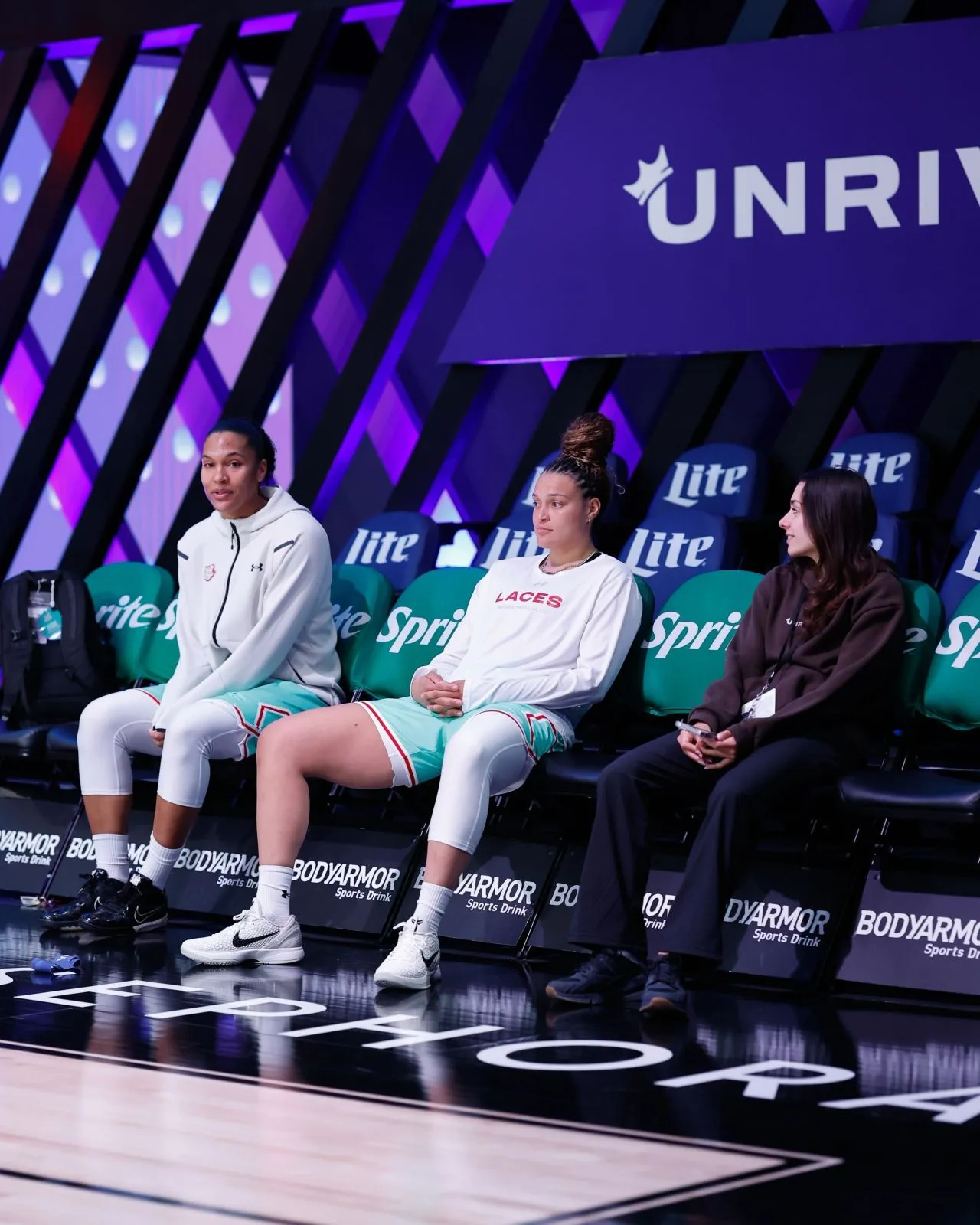 Camilla Flefil seated courtside with Laces WNBA players at an Unrivaled game